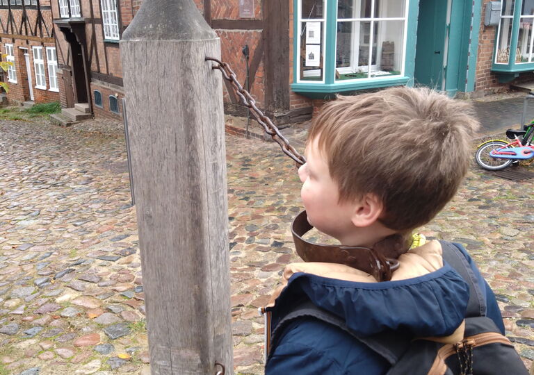 Ein Schüler steht am Pranger